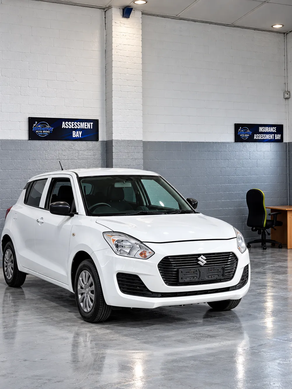 White Suzuki Swift in the Creative Auto Worx assessment bay